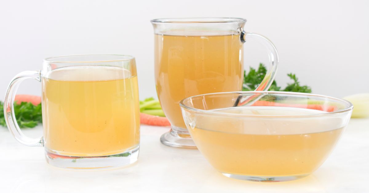 Chicken broth in glass mugs and a bowl as an example of full liquid diet staple